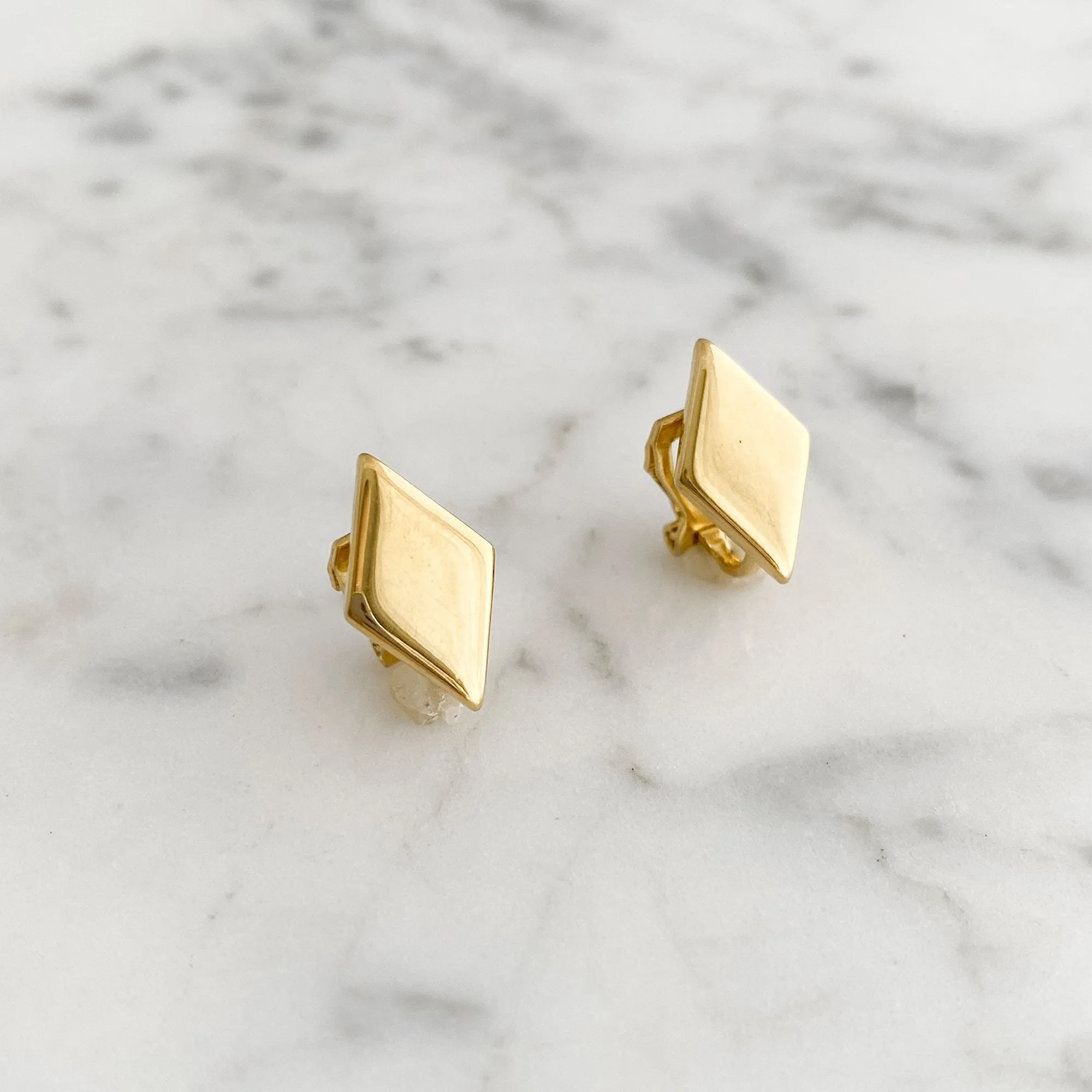 GASTON diamond shaped gold tone clip earrings